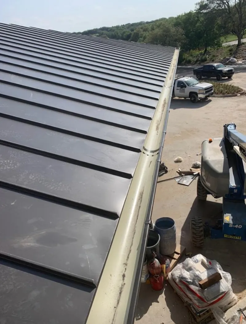 Standing seam panel and gutter detail on a metal roofing jobsite in Enterprise